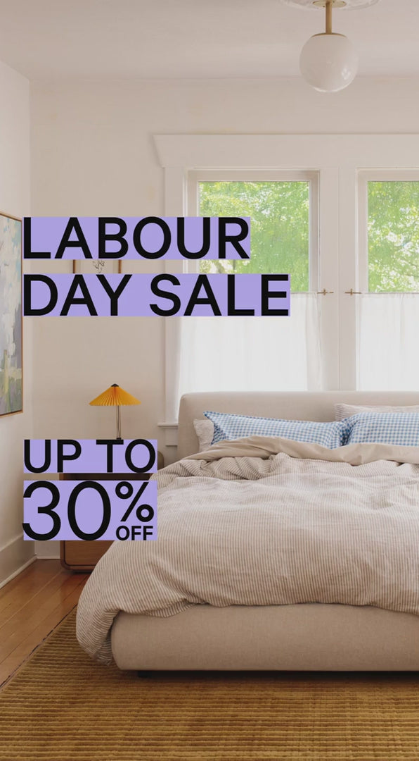 Up to 30% off sale stickers over a neutral bedroom.