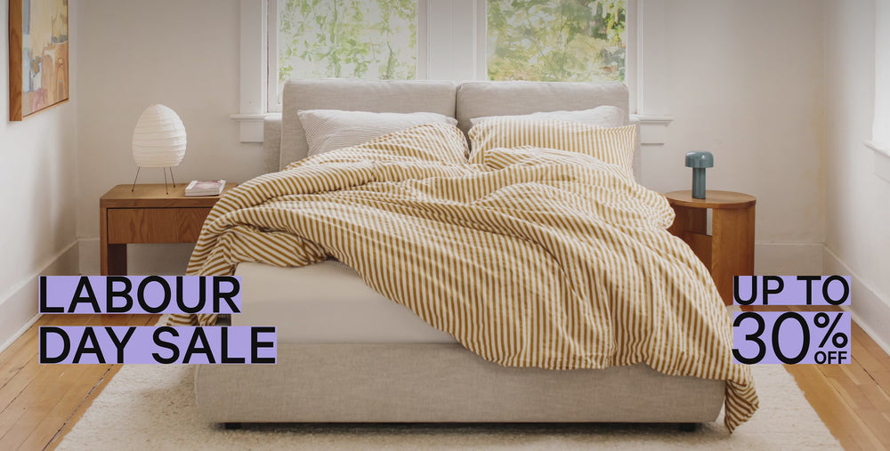 Up to 30% off sale stickers over a neutral bedroom.